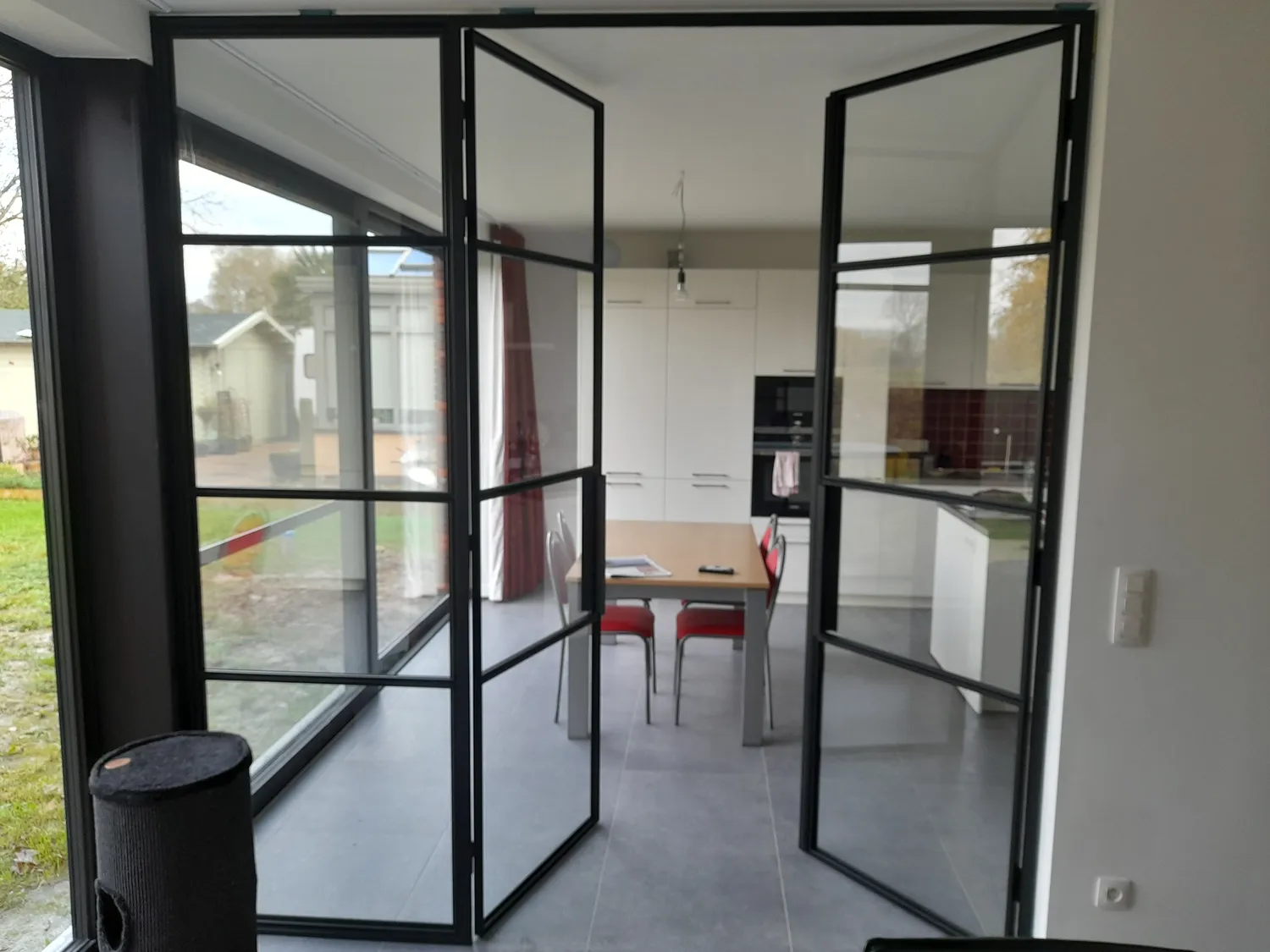 Fixed steel and glass screen dividing an interior