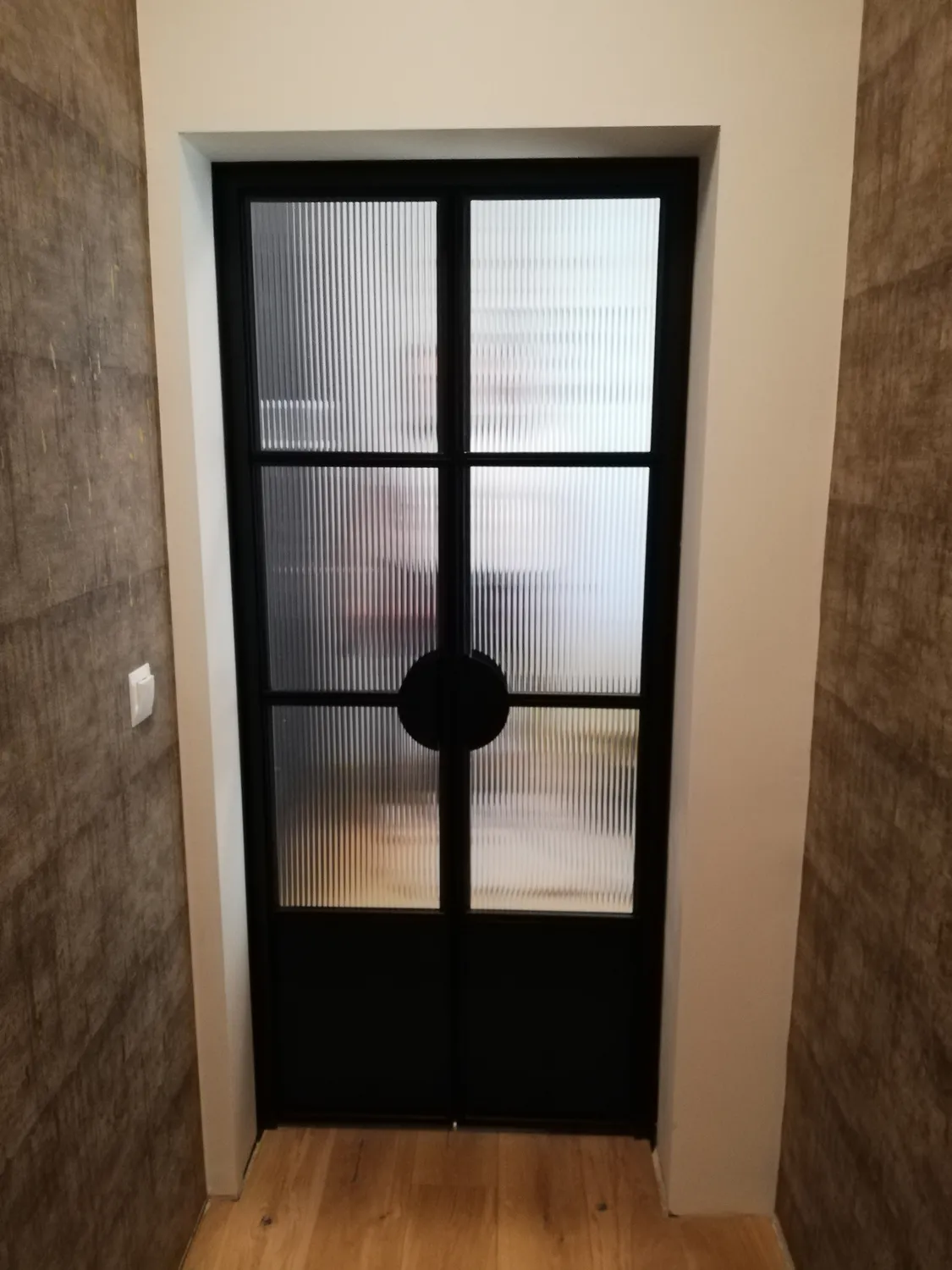 Steel and glass door detail within a trade supply package
